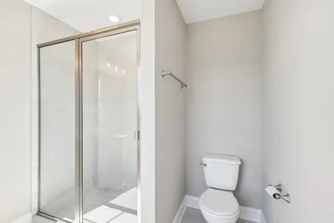 a bathroom with a toilet and shower