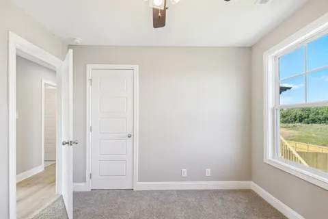 an empty room with windows and closet