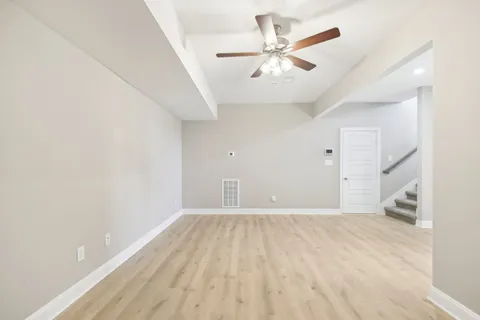 wooden floor in an empty room with a window