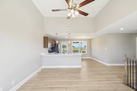 a view of a kitchen with a sink and wooden floor