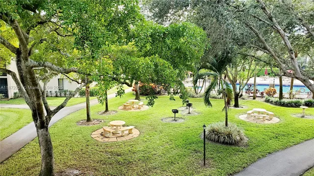 a view of a backyard with large trees