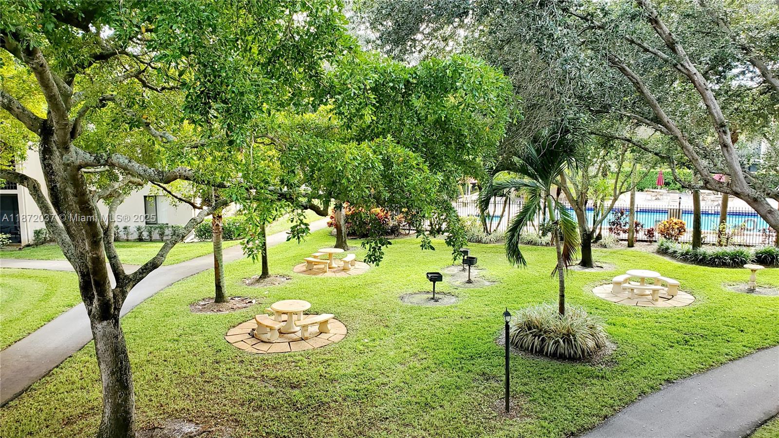 204 Foxtail Drive, Unit D1 Greenacres, FL 33415 - Photo 12 of 12 a view of a backyard with large trees