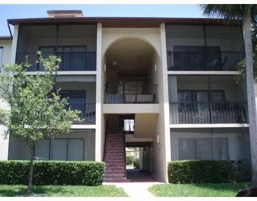 a front view of a house with plants