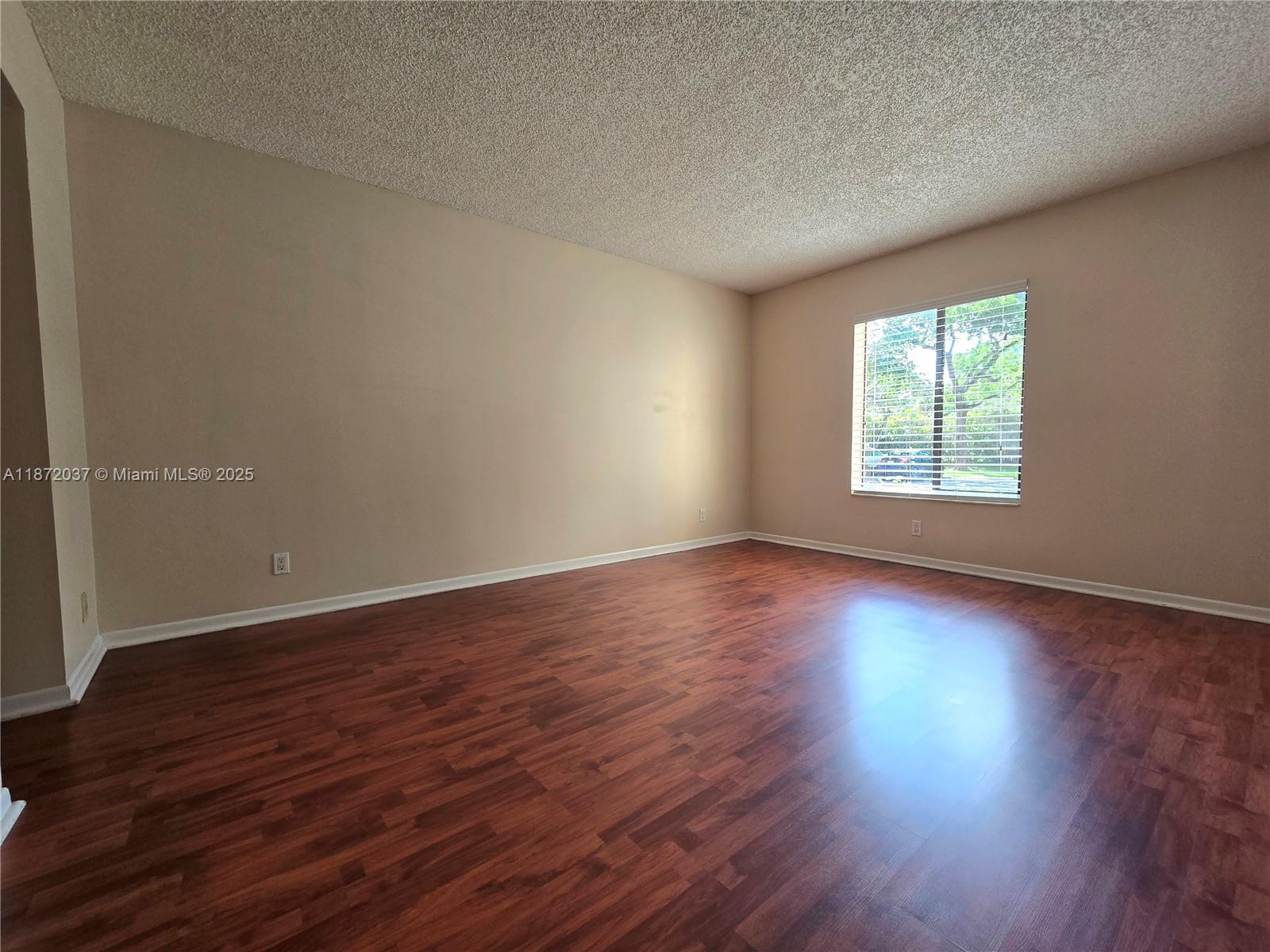 204 Foxtail Drive, Unit D1 Greenacres, FL 33415 - Photo 4 of 12 an empty room with wooden floor and windows