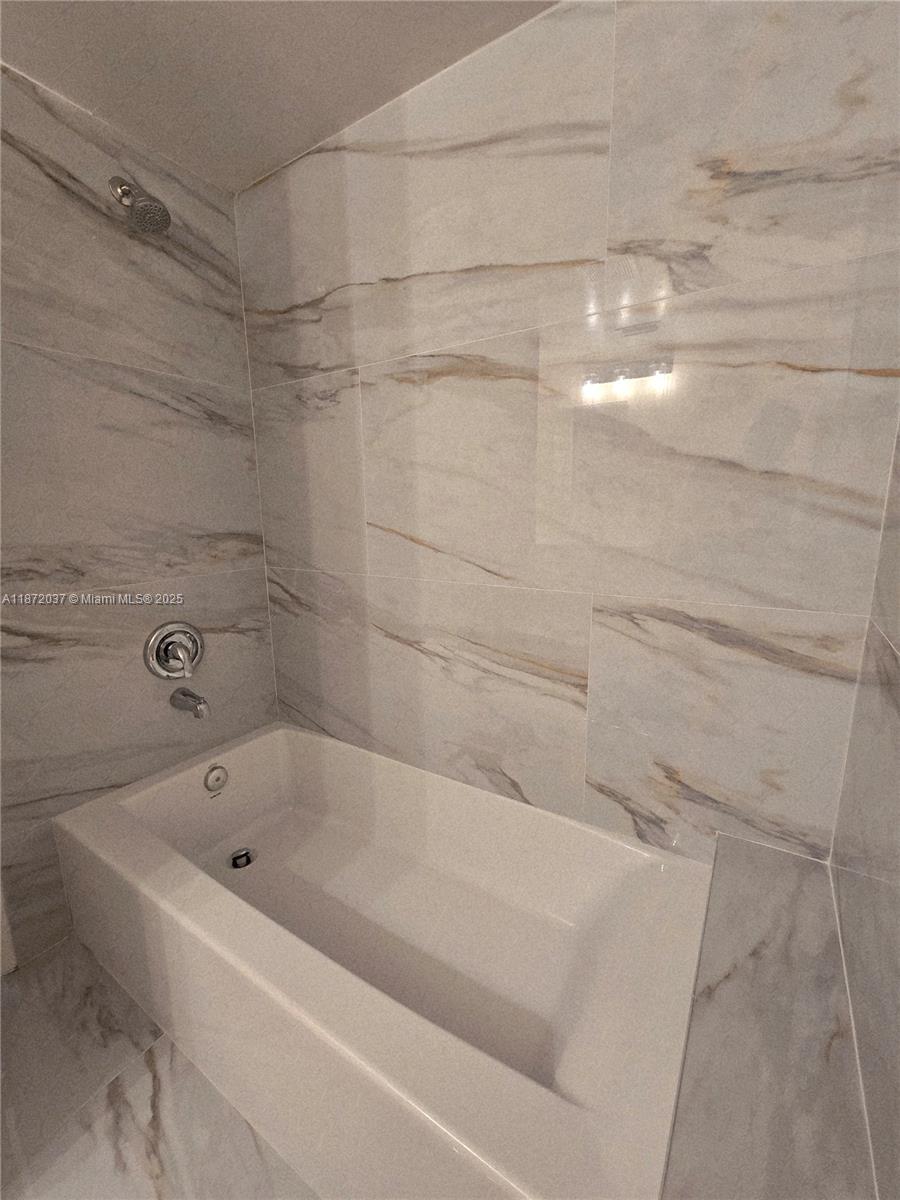 204 Foxtail Drive, Unit D1 Greenacres, FL 33415 - Photo 8 of 12 a bathroom with a bathtub