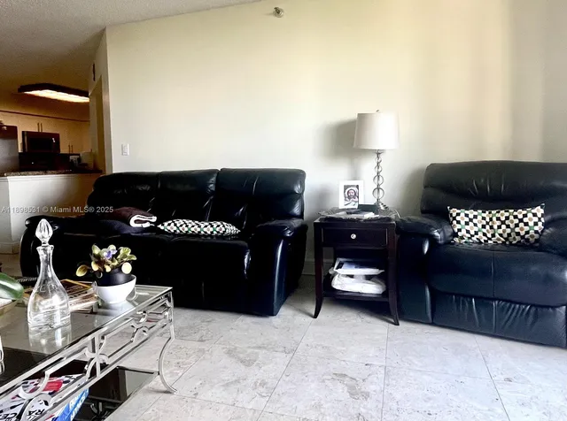 a bedroom with a bed and a lamp on dresser