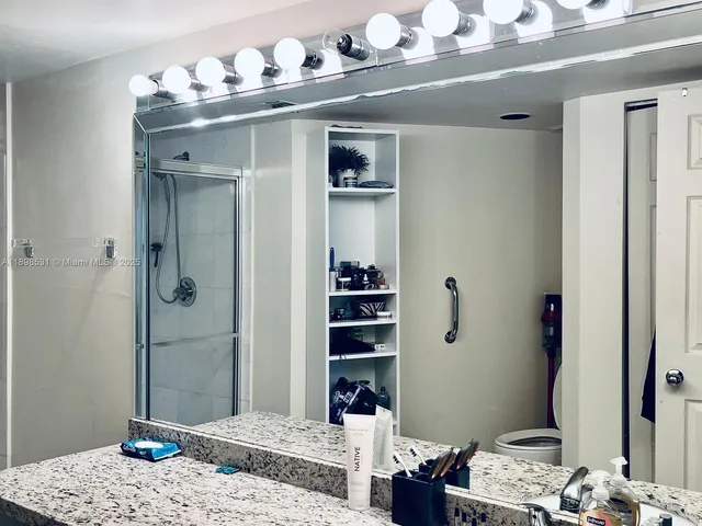 a bedroom with a bed and a mirror