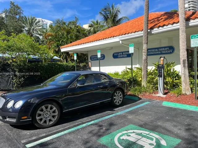 a view of a car parked front of a house