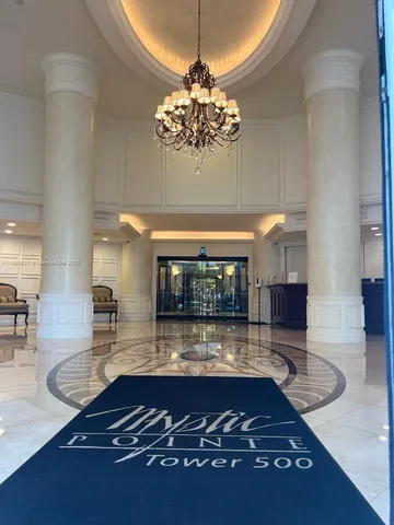 a room with lots of wooden floor and chandelier