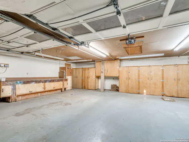 a kitchen with stainless steel appliances granite countertop a sink and a refrigerator