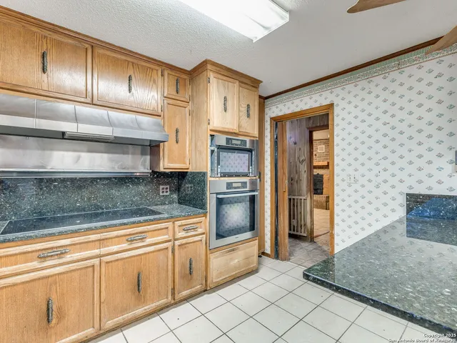 an empty room with closet and fan