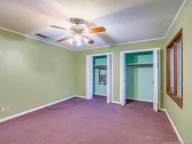 a white toilet sitting next to a shower