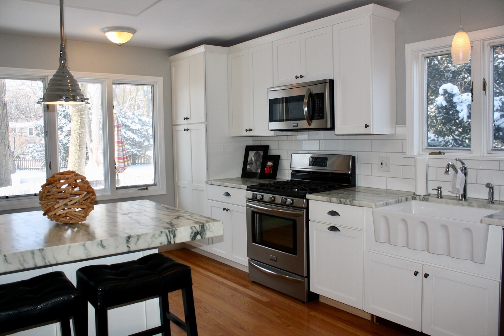 321 North Wright Street Naperville, IL 60540 - Photo 2 of 23 a kitchen with stainless steel appliances granite countertop a stove a sink dishwasher a microwave oven with white cabinets and wooden floor