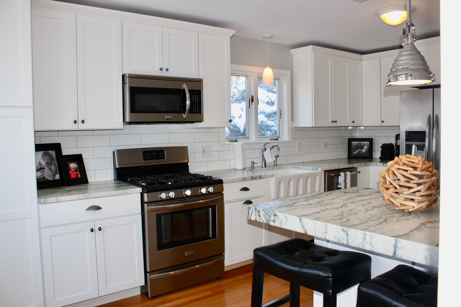 321 North Wright Street Naperville, IL 60540 - Photo 3 of 23 a kitchen with stainless steel appliances a stove a sink a microwave and cabinets
