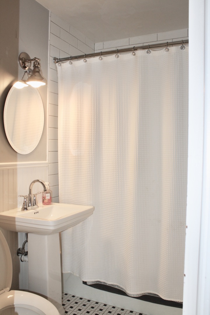 321 North Wright Street Naperville, IL 60540 - Photo 9 of 23 a bathroom with a sink mirror and a bathtub