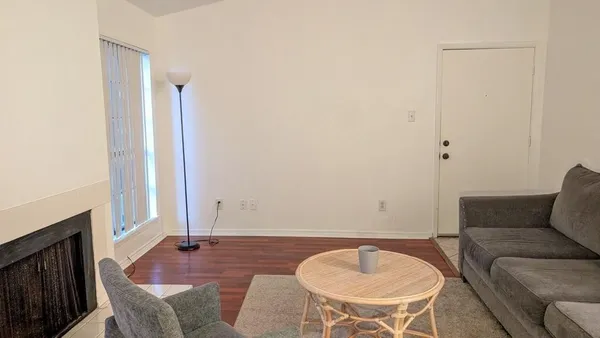 a living room with furniture rug and a fireplace