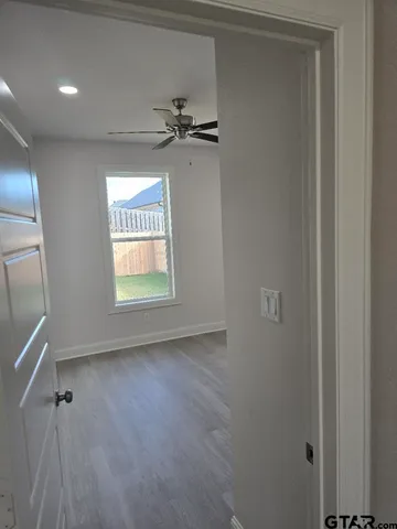 a view of an empty room and a window