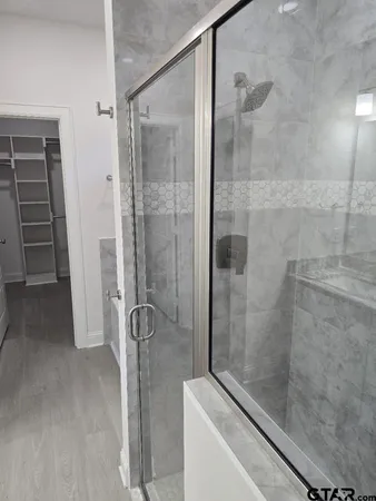 a large kitchen with granite countertop a sink stainless steel appliances and cabinets