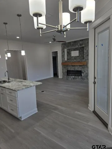 an open kitchen with a sink and a refrigerator