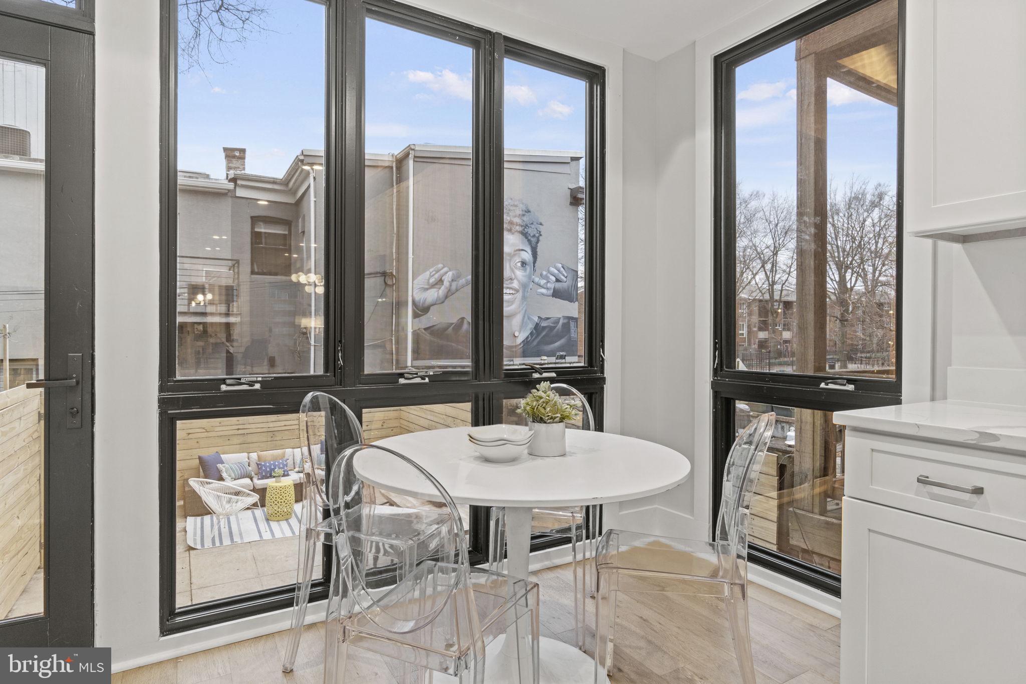 92 R Street Northwest Washington, DC 20001 - Photo 11 of 36 a view of a dining room with furniture large windows and wooden floor