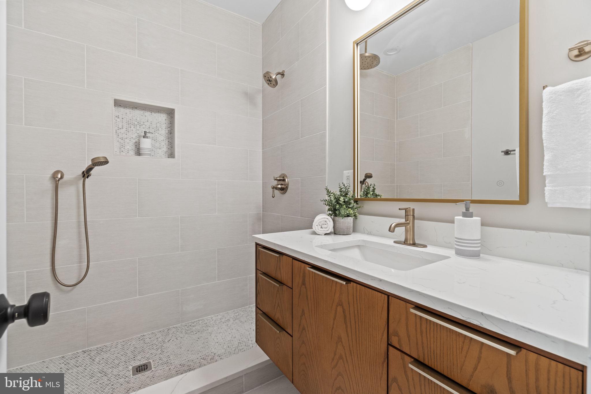 92 R Street Northwest Washington, DC 20001 - Photo 16 of 36 a bathroom with a shower sink and mirror