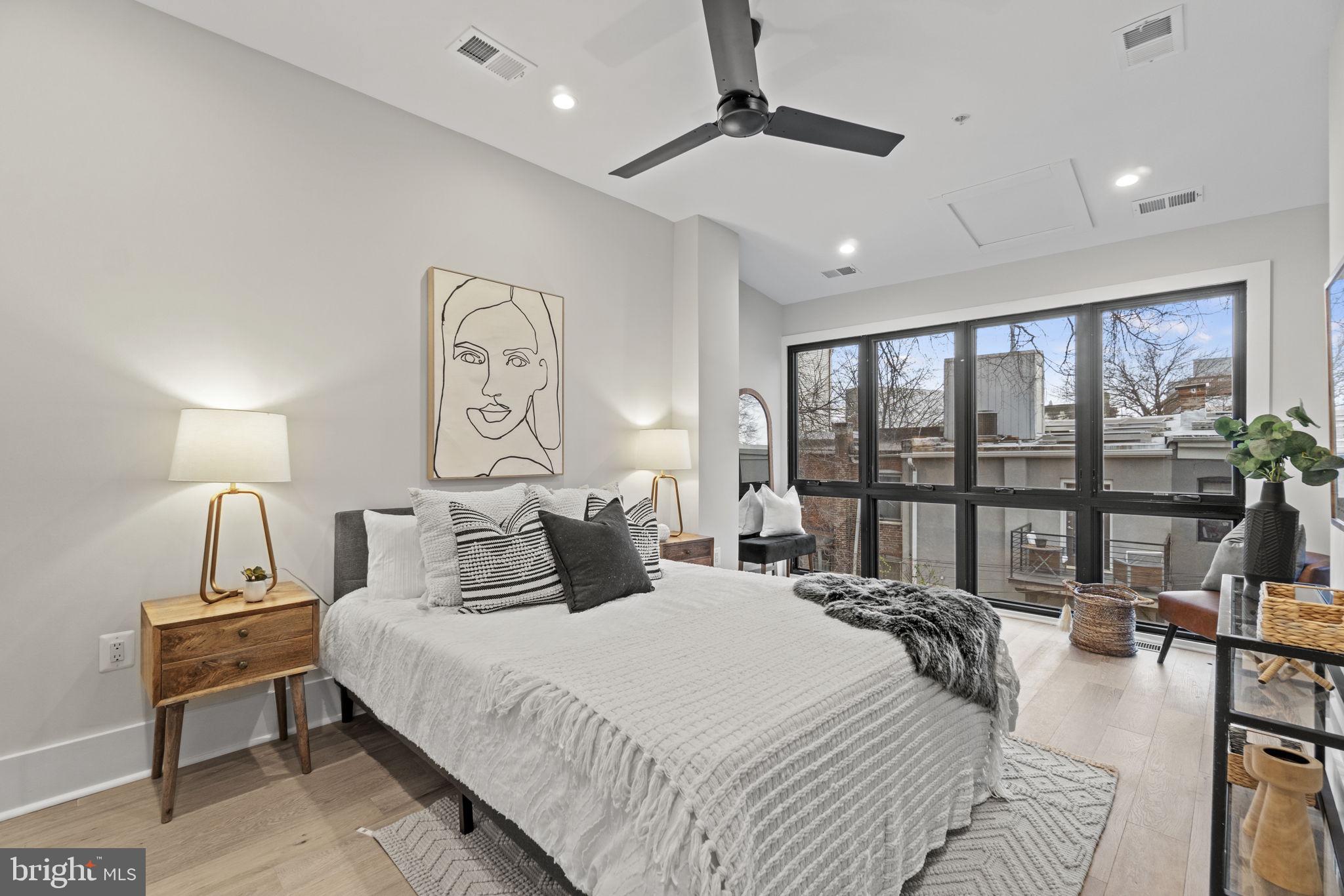 92 R Street Northwest Washington, DC 20001 - Photo 17 of 36 a bedroom with a large bed and a large window