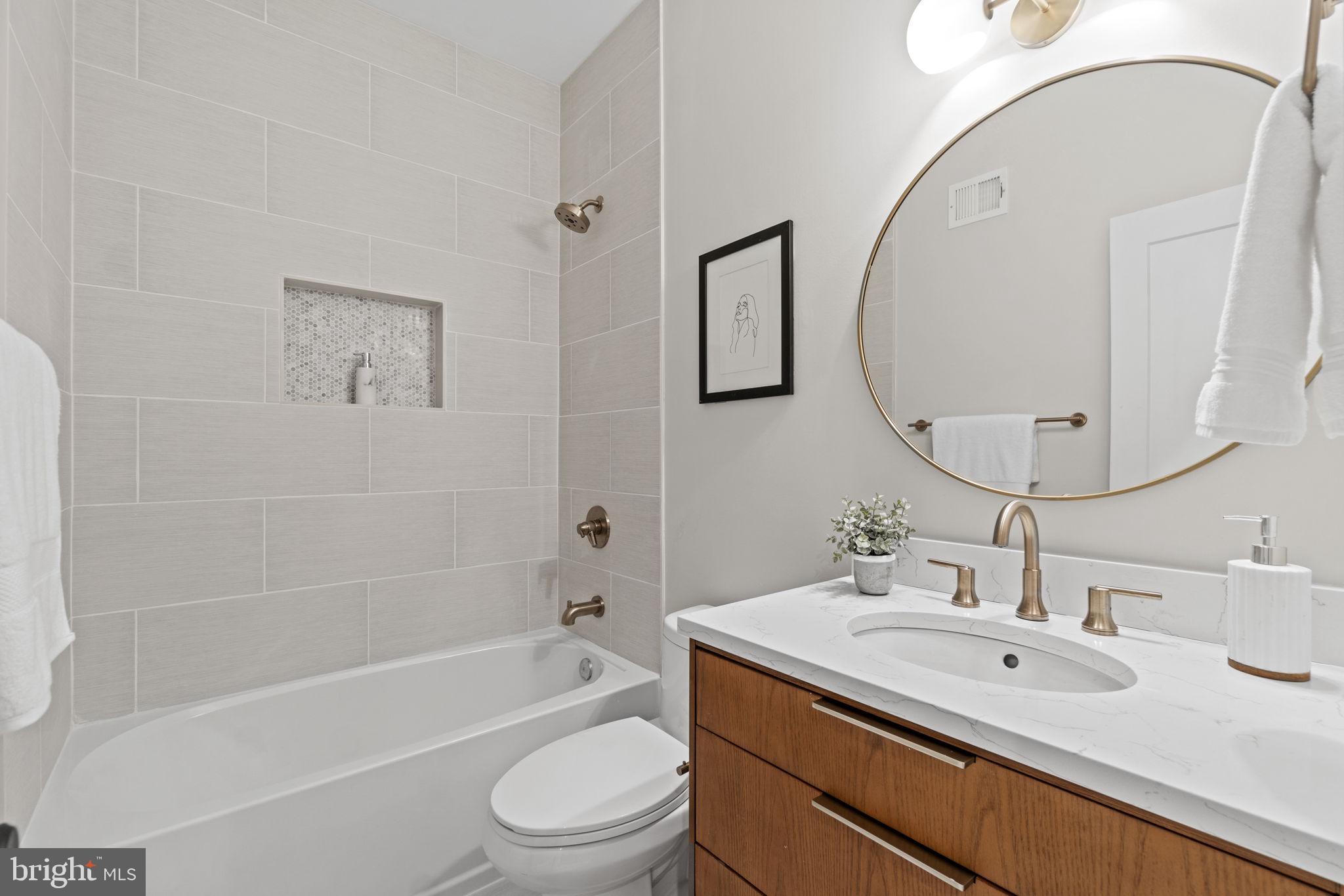 92 R Street Northwest Washington, DC 20001 - Photo 19 of 36 a bathroom with a sink a toilet and a mirror