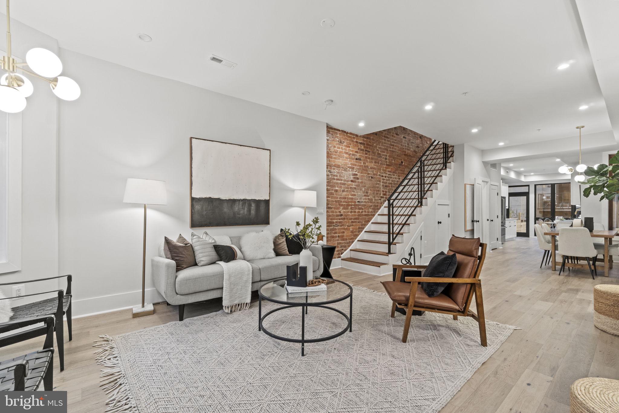 92 R Street Northwest Washington, DC 20001 - Photo 2 of 36 a living room with furniture a rug and a chandelier