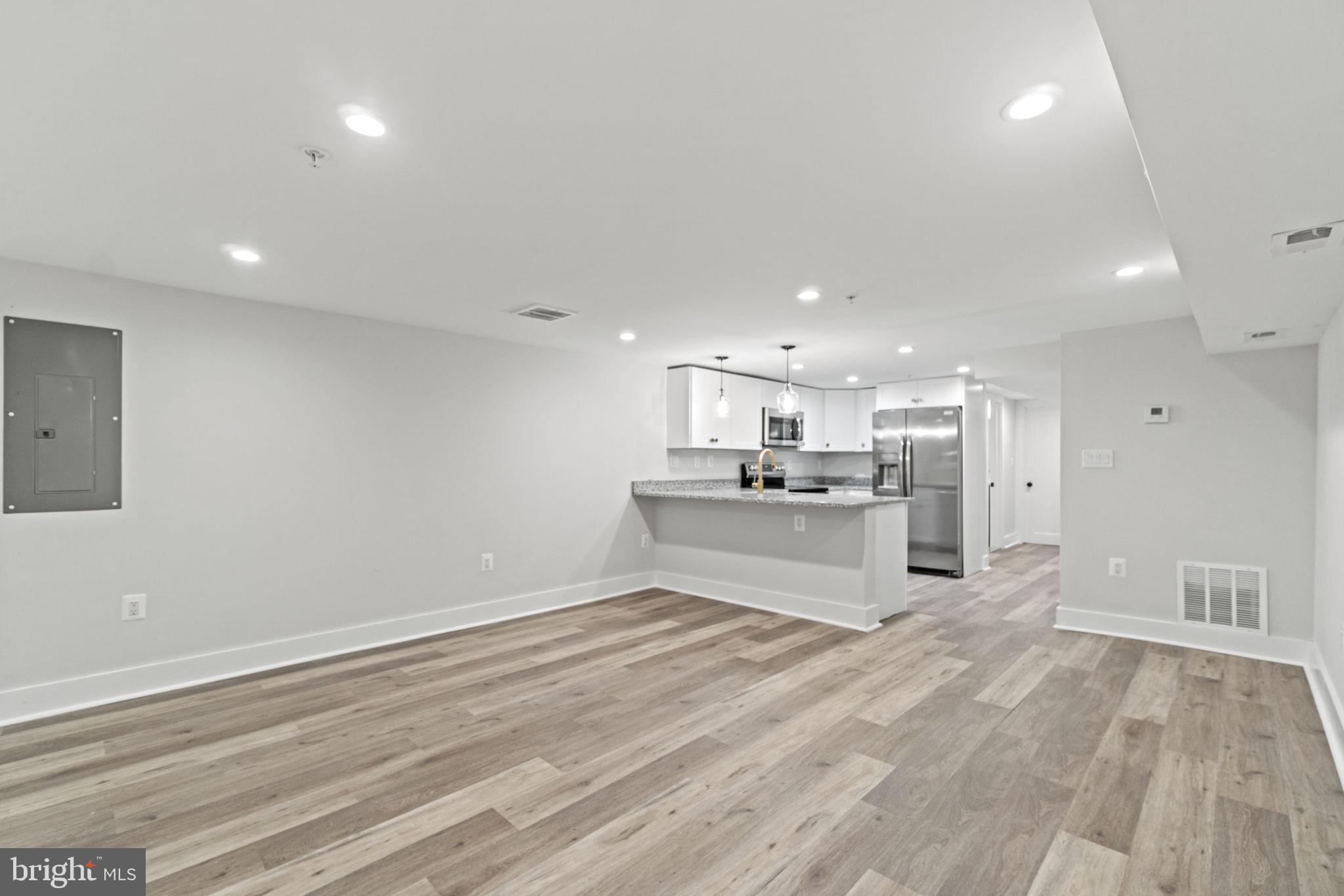 92 R Street Northwest Washington, DC 20001 - Photo 21 of 36 a large white kitchen with kitchen island a sink stainless steel appliances and cabinets