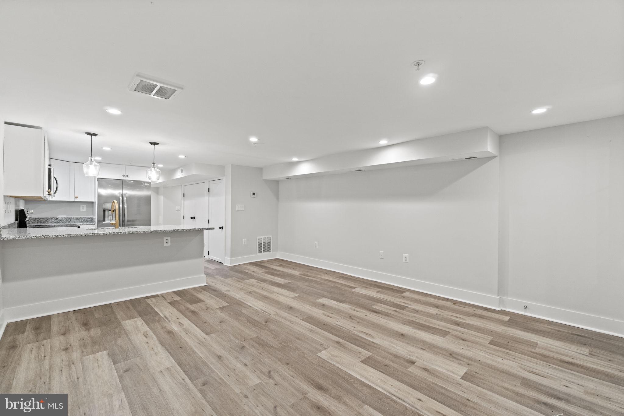92 R Street Northwest Washington, DC 20001 - Photo 23 of 36 a view of kitchen with kitchen island white cabinets and wooden floor