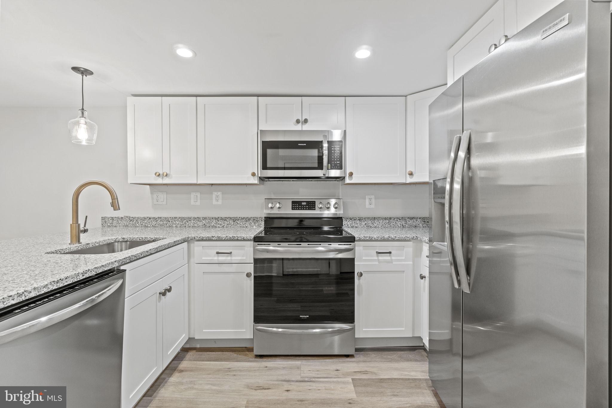 92 R Street Northwest Washington, DC 20001 - Photo 25 of 36 a kitchen with stainless steel appliances granite countertop a stove and a refrigerator