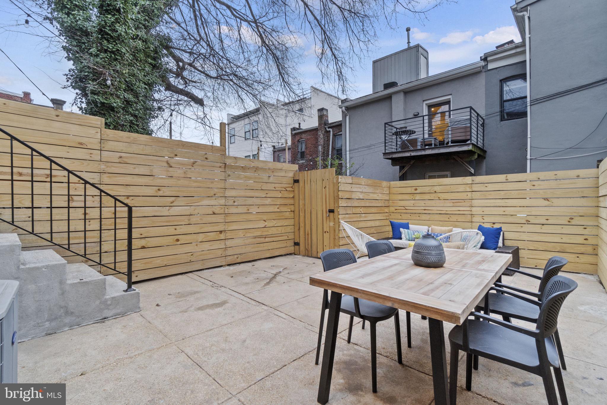 92 R Street Northwest Washington, DC 20001 - Photo 33 of 36 a backyard of a house with barbeque oven and outdoor seating
