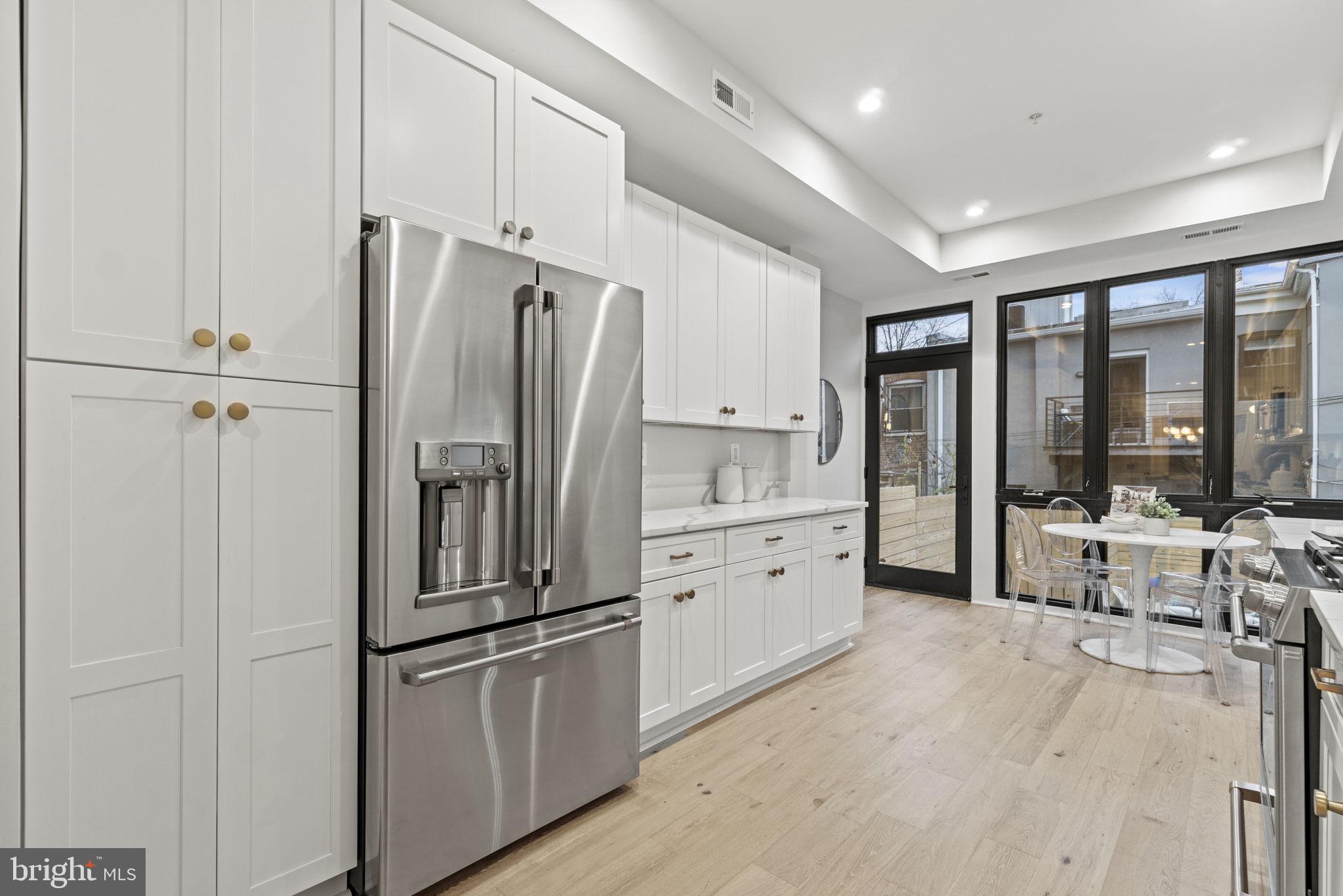 92 R Street Northwest Washington, DC 20001 - Photo 9 of 36 a kitchen with stainless steel appliances a refrigerator sink and cabinets