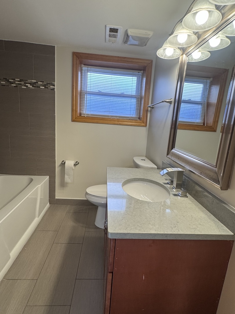 12255 South McDaniels Street, Unit GN Alsip, IL 60803 - Photo 9 of 11 a bathroom with a sink and a mirror