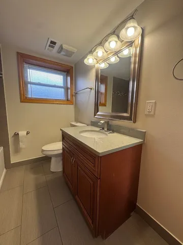 a bathroom with a sink vanity and a mirror