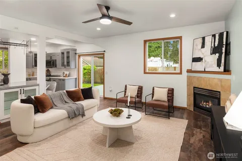 a living room with furniture a window and a fireplace