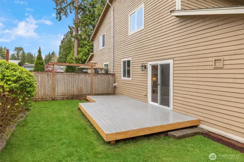 a view of a backyard with plants and a patio