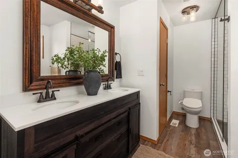 a bathroom with a sink a toilet and a mirror