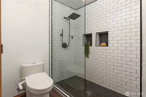 a bathroom with a toilet and a shower