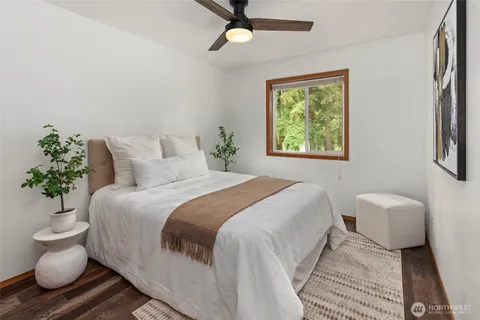 a bedroom with a bed and a potted plant
