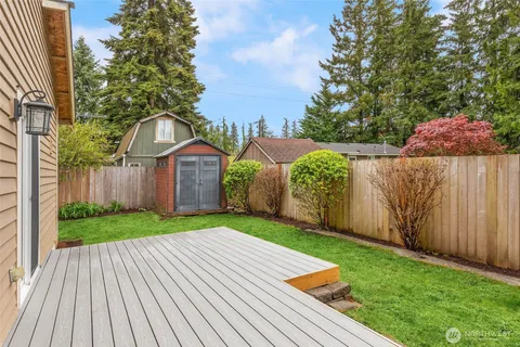 a view of a backyard with wooden fence