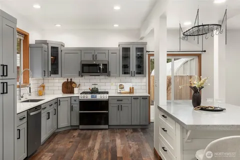 a kitchen with stainless steel appliances a sink stove and refrigerator