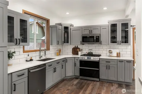 a kitchen with a sink stove and microwave