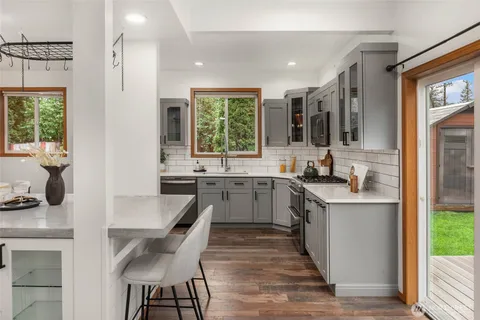 a kitchen with a stove a sink and a refrigerator