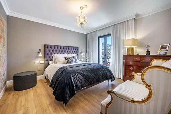 a bedroom with a bed and a lamp