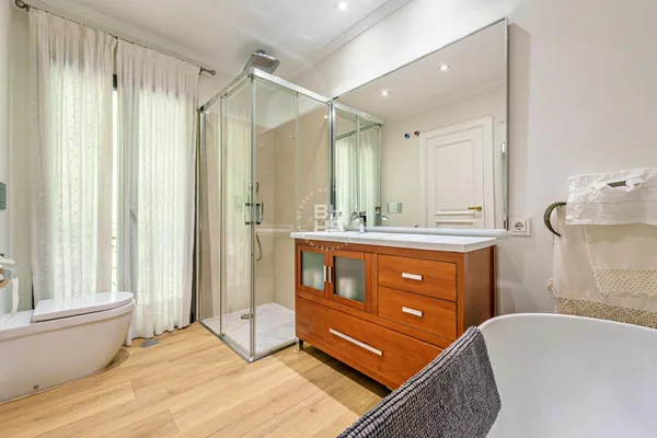 a bathroom with a sink vanity granite tub and shower