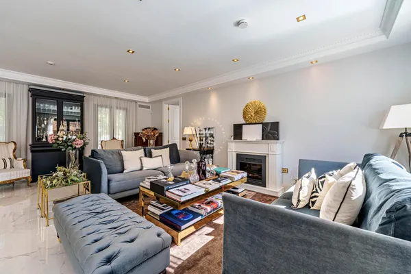 a living room with furniture fireplace and window