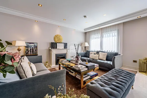 a living room with fireplace furniture and a window