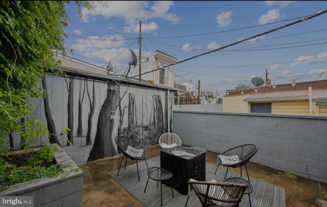 401 South Ann Street Baltimore, MD 21231 - Photo 14 of 30 a view of a patio with table and chairs with wooden floor