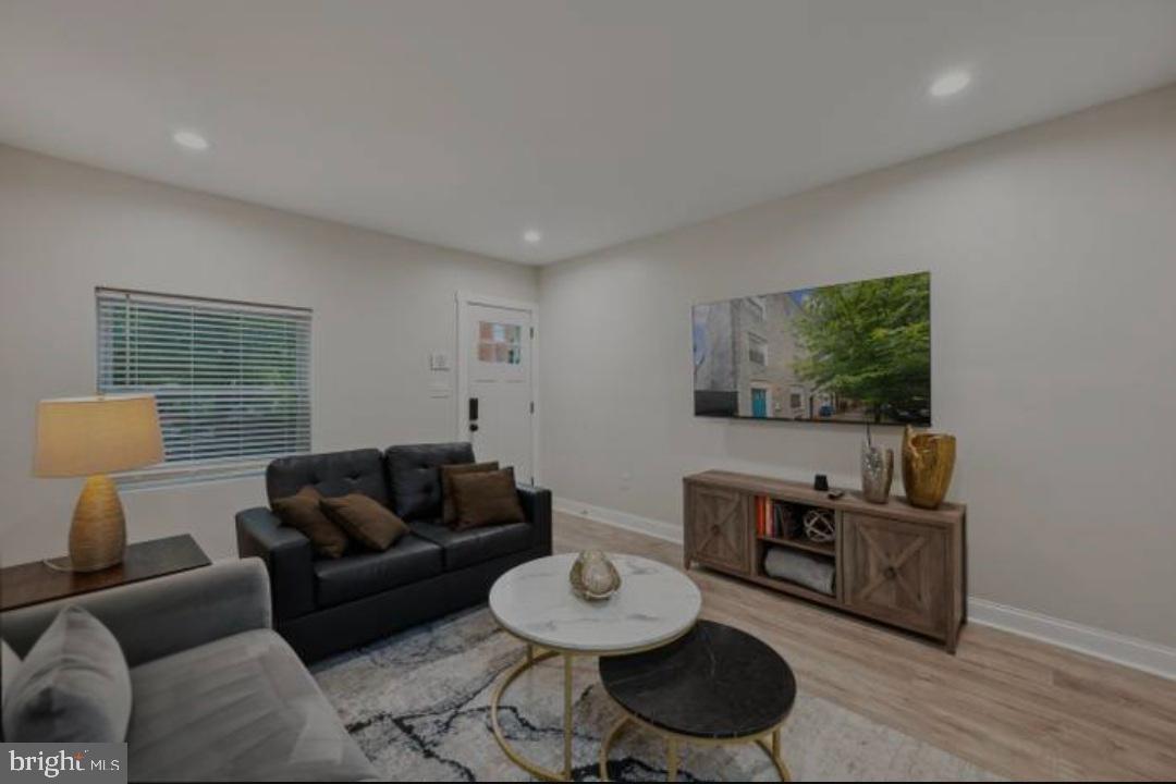 401 South Ann Street Baltimore, MD 21231 - Photo 17 of 30 a living room with furniture a rug and a window